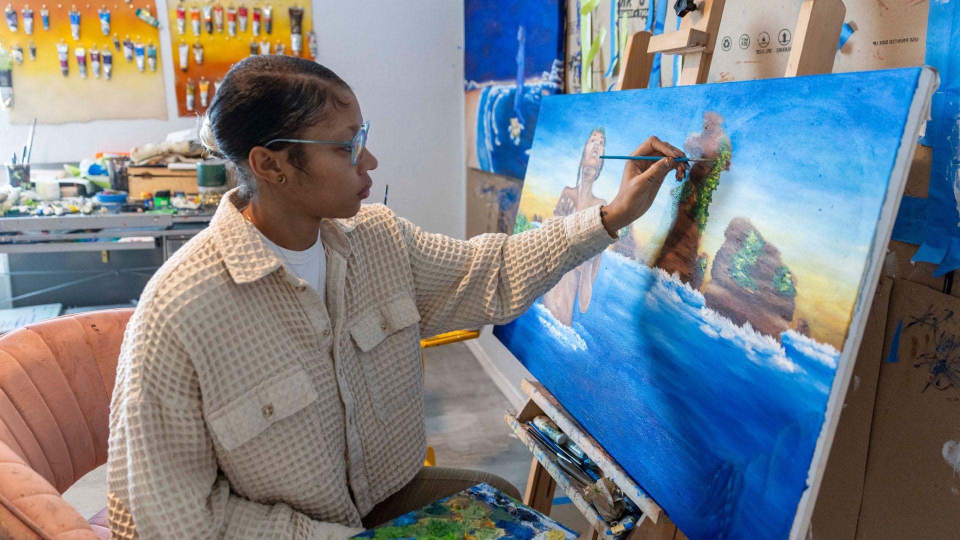 A person painting on a canvas.